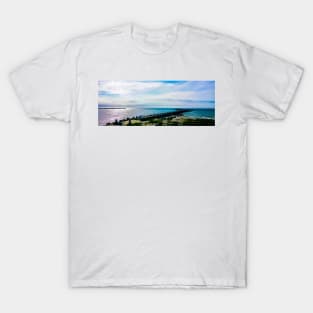 Pier with concrete breakwaters. Seascape, glare on the water of the Baltic Sea, rays of light T-Shirt